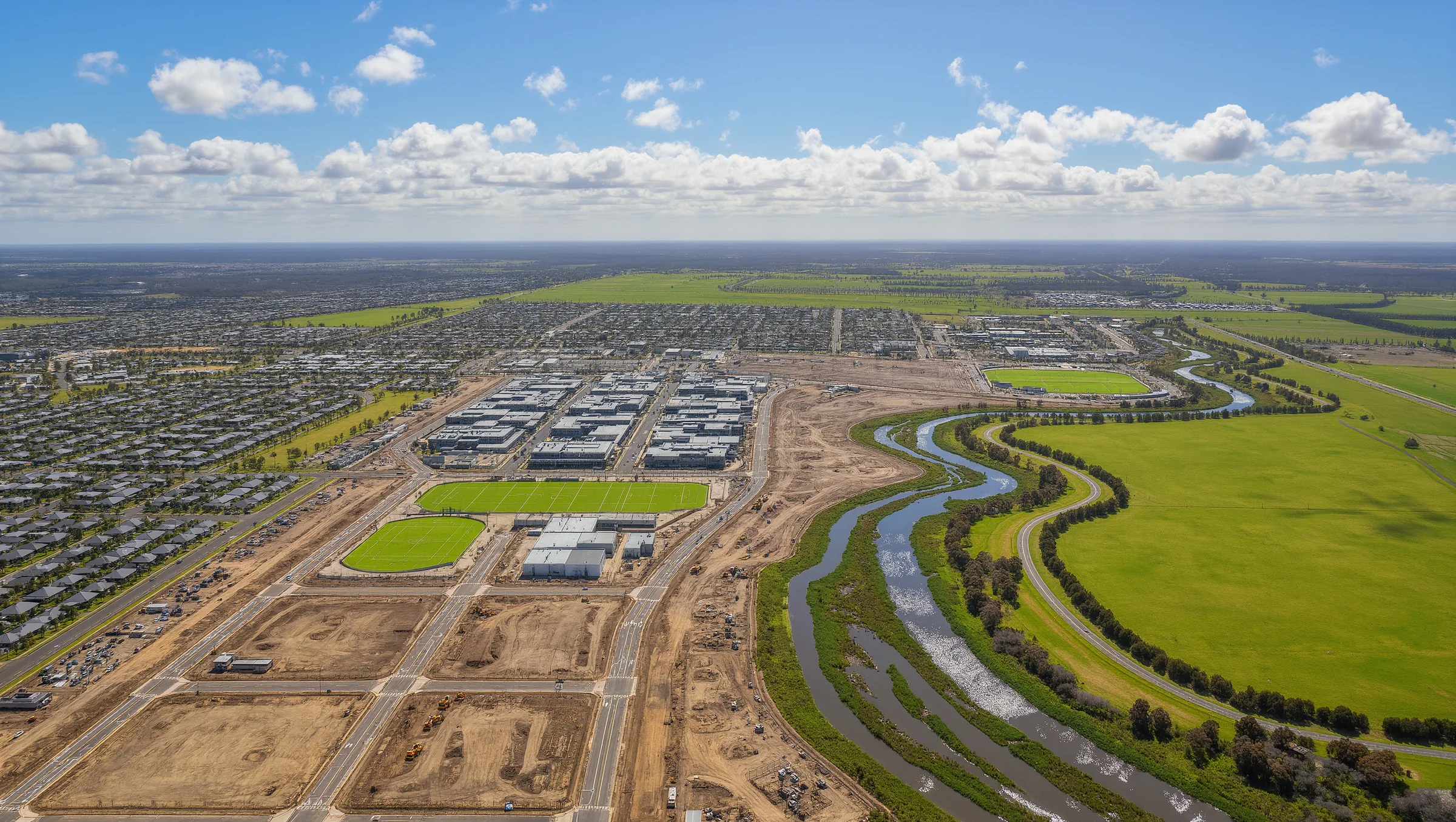 Aerial view of the Kororoit growth precinct at dusk with future community layout